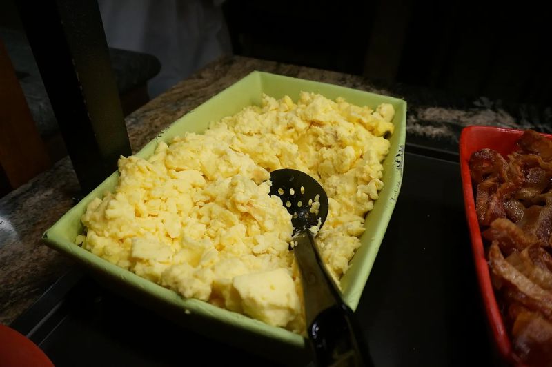 Scrambled Eggs From A Metal Tray