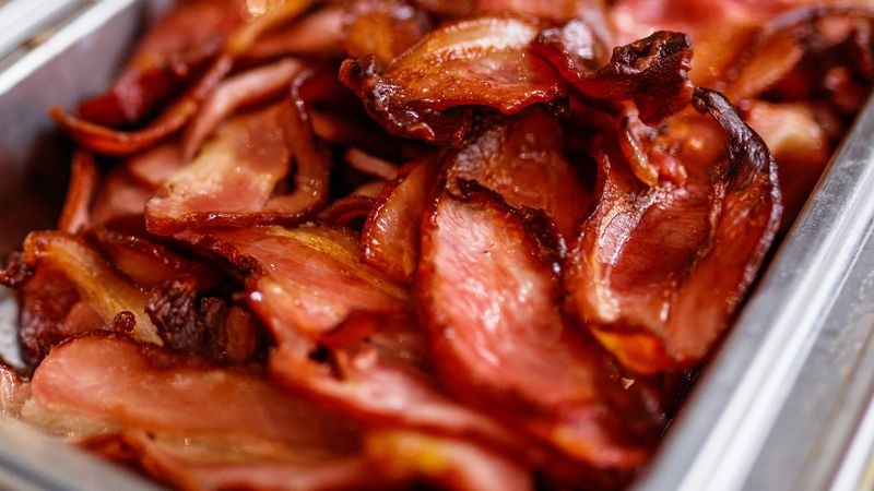 Buffet Bacon Sitting Under Heat Lamps