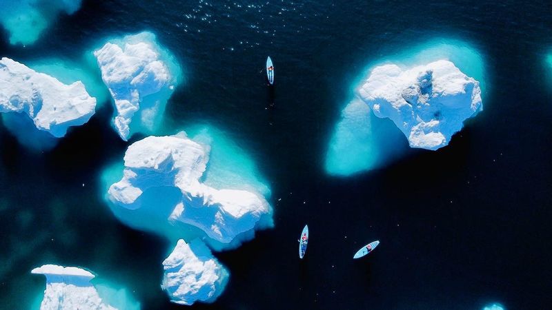 Kayak Among Icebergs in Greenland